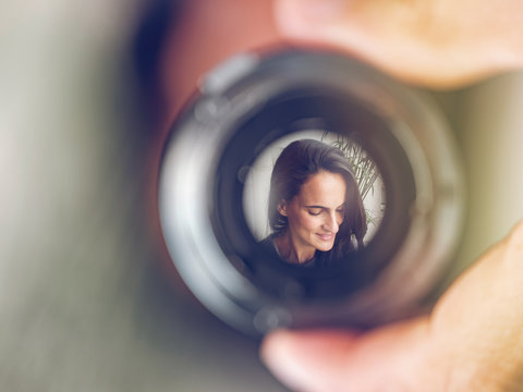Reflection of woman in lens