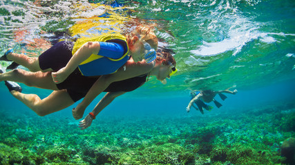 Happy family - father, mother, kids in snorkeling mask dive underwater with tropical fishes in coral reef sea pool. Travel lifestyle, watersport adventure, swimming on summer beach holiday with child. - obrazy, fototapety, plakaty