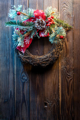 Fototapeta na wymiar Christmas wreath on a rustic wooden door.