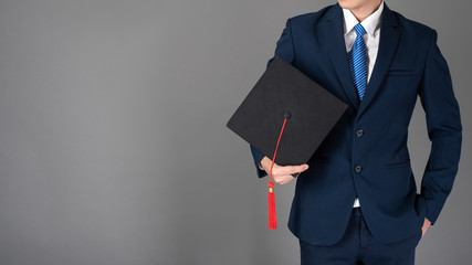 business man is holding graduation hat, business education concept