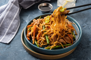 Asian noodles with pork in teriyaki sauce, with green beans, carrots and shiitake mushrooms.