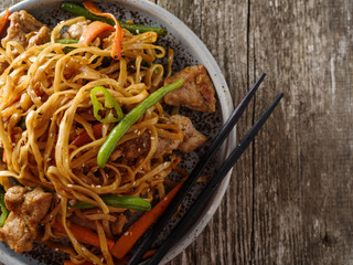 Asian noodles with pork in teriyaki sauce, with green beans, carrots and shiitake mushrooms.