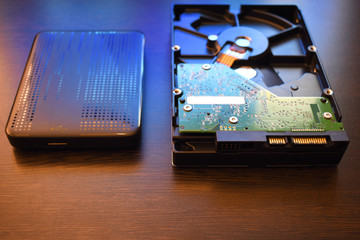 Hard disk and portable hard disk on a wooden table