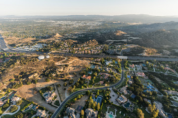 Late afternoon aerial view of homes, estates, mansions and the 118 freeway in the Chatsworth neighborhood of Los Angeles, California.