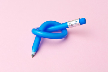 Flexible pencil on pink background. Bent pencils. Flexible business concept.