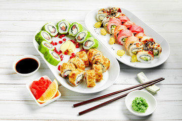Closeup of traditional japanese sushi set with salmon and tuna fish isolated on white background. Sushi bar menu design with copyspace.