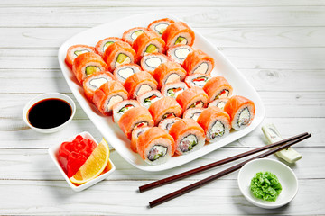 Closeup of traditional japanese sushi set with salmon and tuna fish isolated on white background. Sushi bar menu design with copyspace.
