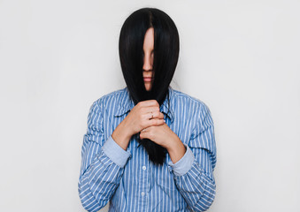 The young girl covered her face with hair. Hide from the problems. Introvert personality.