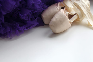 Ballet dance shoes and purple lace skirt with rhyches. Pink satin ribbons. Children's dream