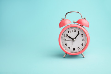 Red alarm clock on blue background
