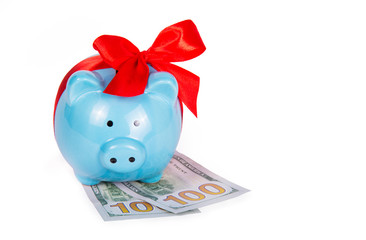 Piggy bank with red bow. Piggy bank and dollars