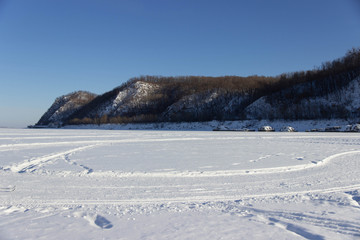 view of the snow field with mountains in the distance