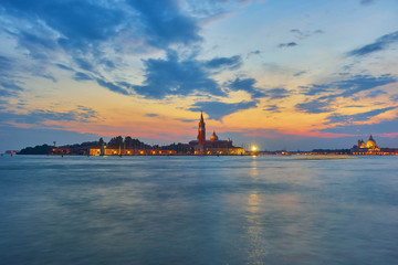 Naklejka premium Scenic view of St George Church and Island in the Giudecca Canal, as seen at night from St Mark's district in Venice