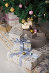 Naklejka na ściany i meble Beautiful silver and gold boxes with gifts under the Christmas tree