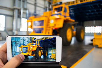 Big mining truck in the production shop of the car factory. Beautiful picture of the truck in the mobile phone