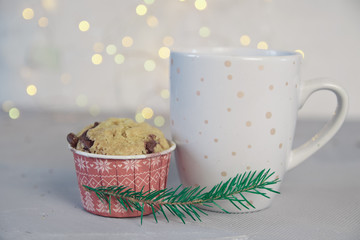Chrismas concept cup of coffee, mini cake ,on the light background