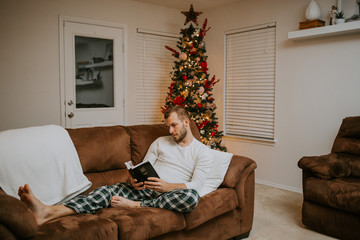 Man reading from Bible at Christmas
