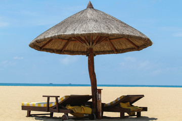 Beach chairs with umbrella and beautiful sand beach