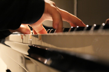 A child's hands playing the piano