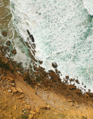 Aerial drone top view of rocky coastline on sunny summer day