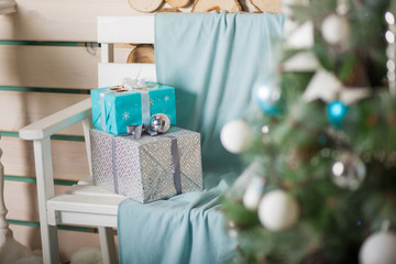 Beautiful white and turquoise boxes with gifts under the Christmas tree