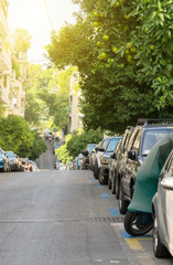 Fototapeta na wymiar Cars parked along the street in Athens.