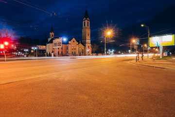 Fototapeta na wymiar Soviet street at night with the Roman Catholic Church of the Mot