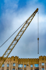 Upper part of the construction crane above the building