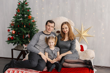 Very cheerful and beautiful family in the New Year's room.