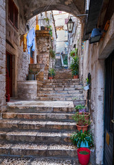 Through the streets of the old historic part of the fortress city of Dubrovnik Croatia.  Stone stairs leading up to the upper part of the city