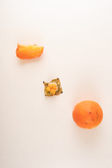 Whole, cut and finished persimmon pieces on the table