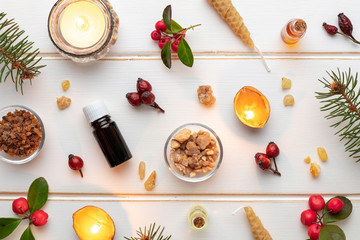 Christmas background with essential oil bottles, frankincense, myrrh and wintergreen