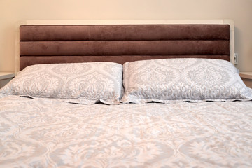 Fototapeta na wymiar Headboard of a double bed with pillows. Scandinavian style