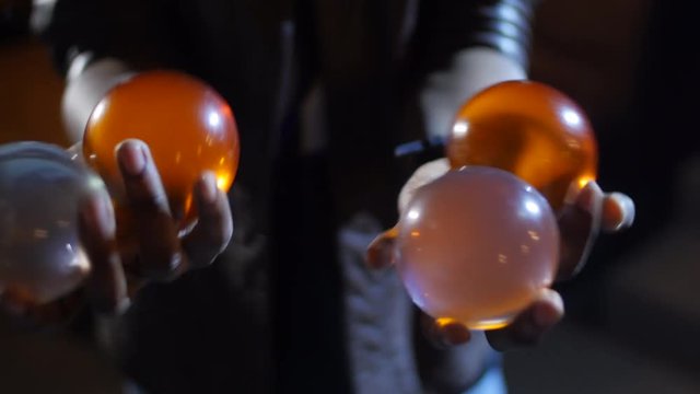 4K Black Magician juggles four balls. Two in each hand