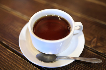 White cup with black tea