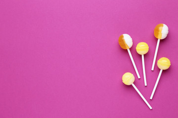 Sweet lollipops on crimson background