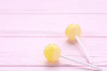 Sweet lollipops on pink wooden table