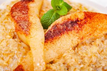 Oatmeal porridge with pear. Close up