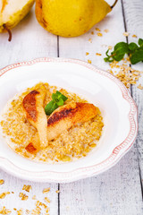 Oatmeal porridge with pear in white plate. Close up