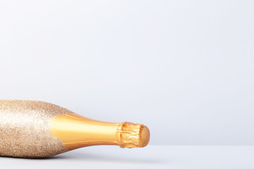 Decorated champagne bottle on grey background