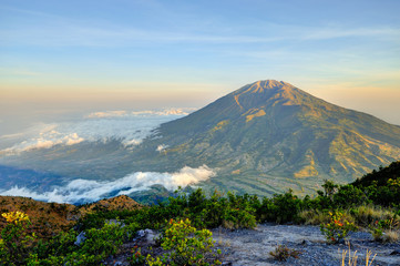 Fantastic view of Merbabu mountain at sunrise from Merapi volcano. Central Java, Indonesia