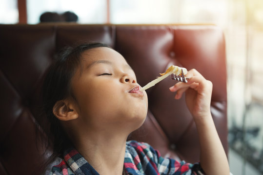 Children Girl Enjoy Eating Cheese From Pizza