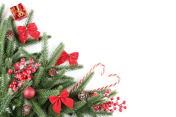 Obraz na płótnie Canvas Christmas fir tree branches with decorations on white background