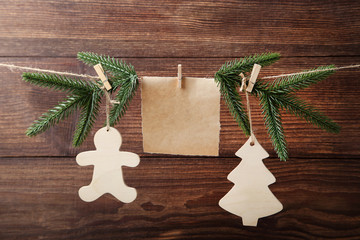 Christmas decorations with blank sheet of paper hanging on rope