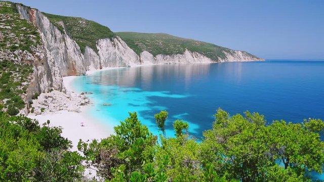 Blue lagoon with rocky coastline, Kefalonia, Greece. Calm clear blue emerald green turquoise sea water. White beach, summer feeling, vacation, travel in paradise. Amazing Ftery beach.