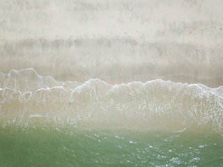 Aerial view of waves on the sandy beach