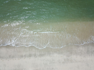 Aerial view of waves on the sandy beach