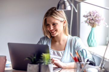 Beautiful young woman working at home office