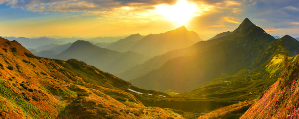 Panoramic view of evening highland with mountain rhododendron