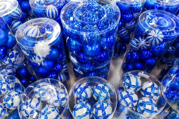 Sale of Christmas toys in the supermarket. Balls of blue colors for the Christmas tree on the supermarket shelves. Christmas toys for sale in the store. Variety of  blue glass balls